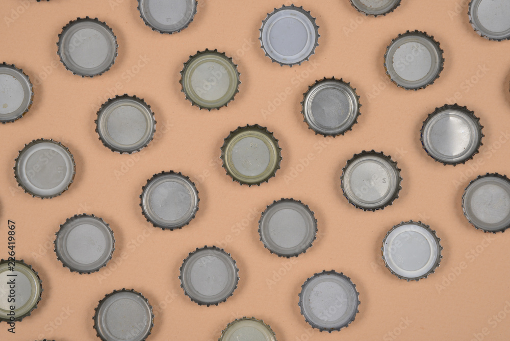 bottle caps lined up in color background.