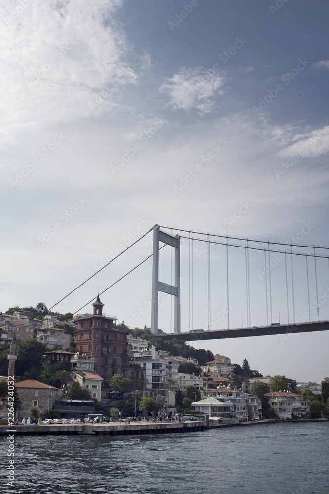 View of people walking by Bosphorus, FSM bridge and European side in Istanbul.