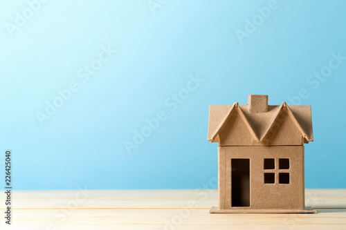 Mini residential craft house on a blue background photo