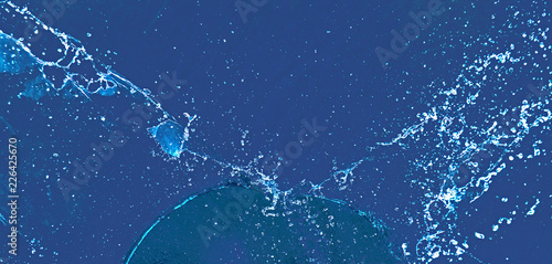 Splashes of water on a blue background. Blue background made of water, splash and drops