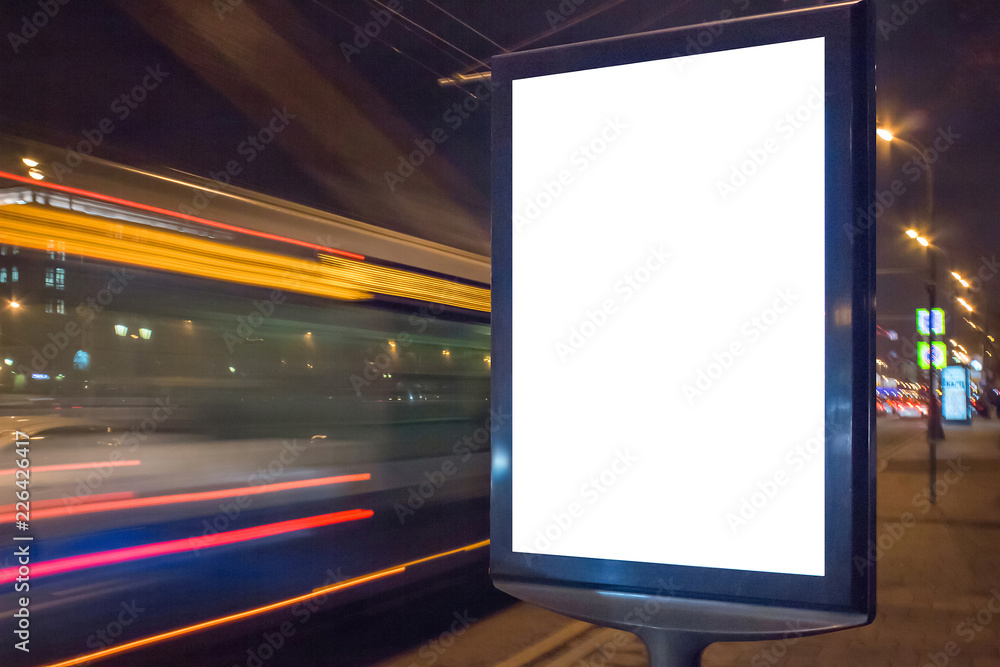 Fototapeta premium Blank white lightbox at night. Mock-up design concept. Car lights in motion blur