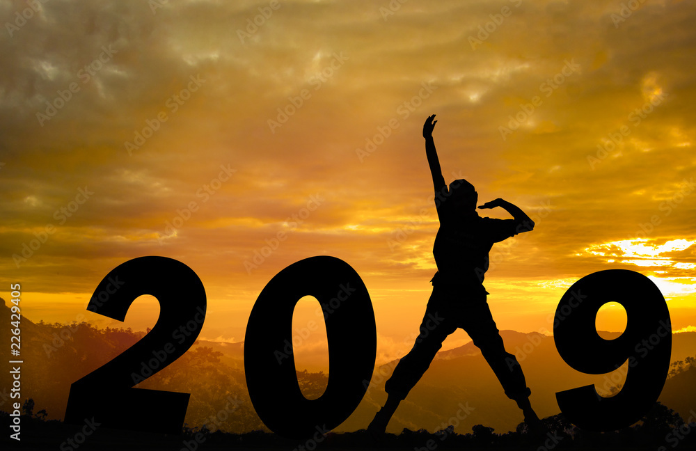 Happy new year Silhouette sunset background.She is jumping instead number 1 word. She standing between 20 and 9.new year,success ,2019, Photo Silhouette and new year concept idea. Happy new year Silhouette sunset background.She is jumping instead number 1 word. She standing between 20 and 9.new year,success ,2019, Photo Silhouette and new year concept idea.