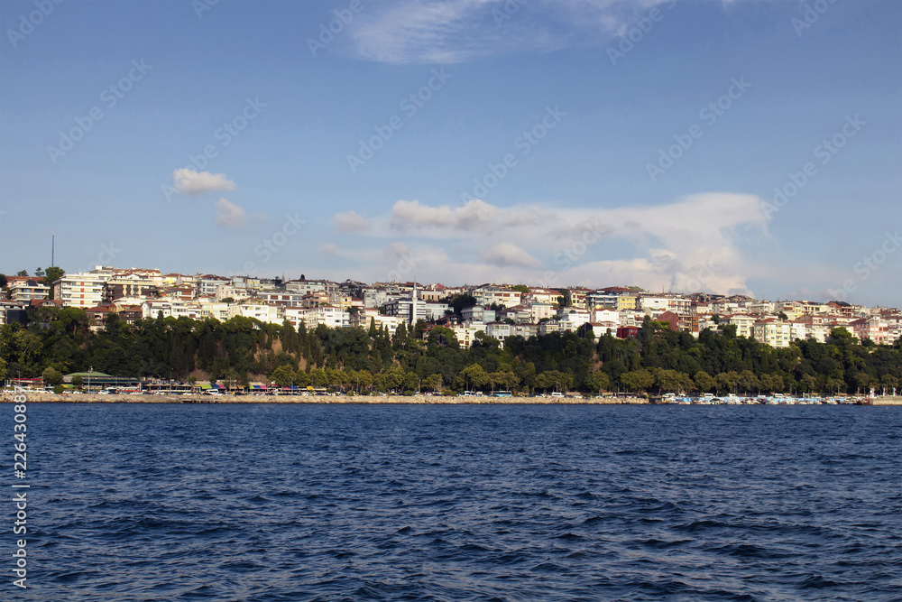 View of the Asian side of Istanbul from a boat. It is a sunny summer day.