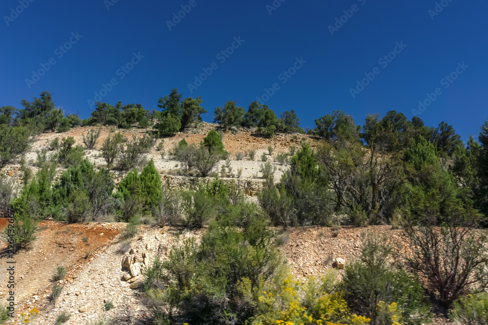 sandstone mountain against blue sky background