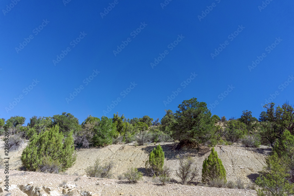 sandstone mountain against blue sky background