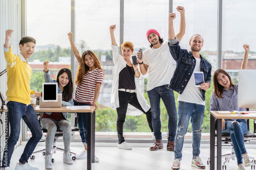 Portrait Group Of Asian and Multiethnic Business people in happy action and celebrate with technology device themself when project is completed in the modern workplace, people business group concept