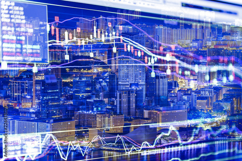 Slika na platnu Double exposure of stocks market chart in blue on LED display concept with city