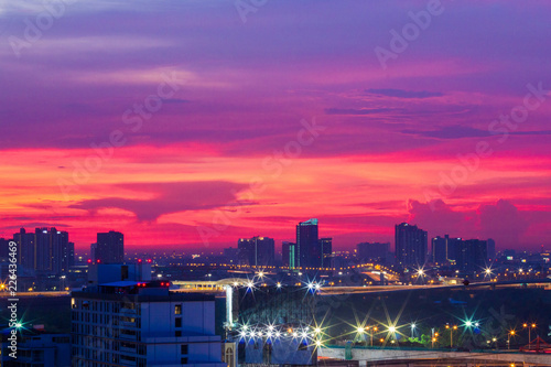 Building at the sunset with twilight sky blue purple background city landscape with long exposure car light and beautiful cloud