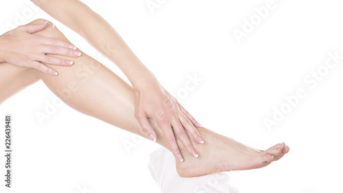 woman applying moisturizing cream on her feet. Skin care concept.