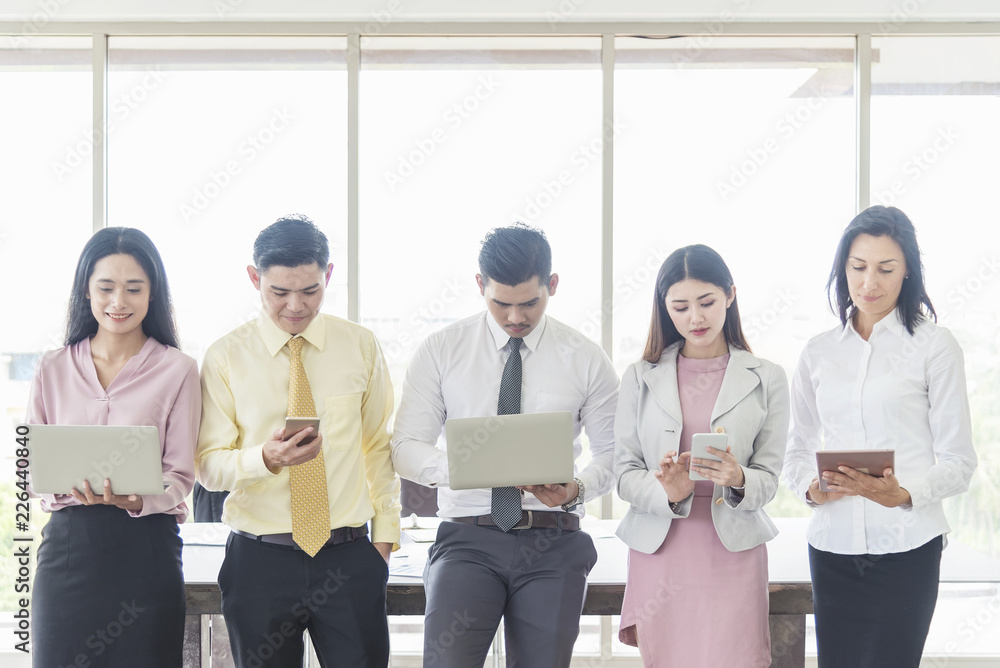 Business and technology concept. Business people working with smartphone, tablet and computer laptop with cheerful in office. Online marketing, global connection and communication. Business and technology concept. Business people working with smartphone, tablet and computer laptop with cheerful in office. Online marketing, global connection and communication.