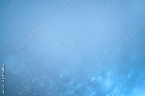Blurred abstract bokeh light of fly water background, Christmas two tone colors.
