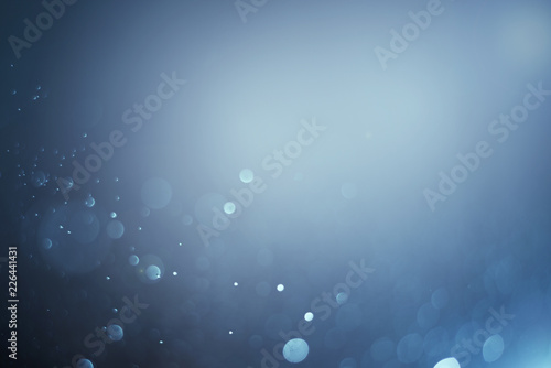 Blurred abstract bokeh light of fly water background, Christmas two tone colors.