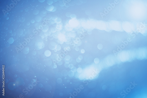 Blurred abstract bokeh light of fly water background, Christmas two tone colors.