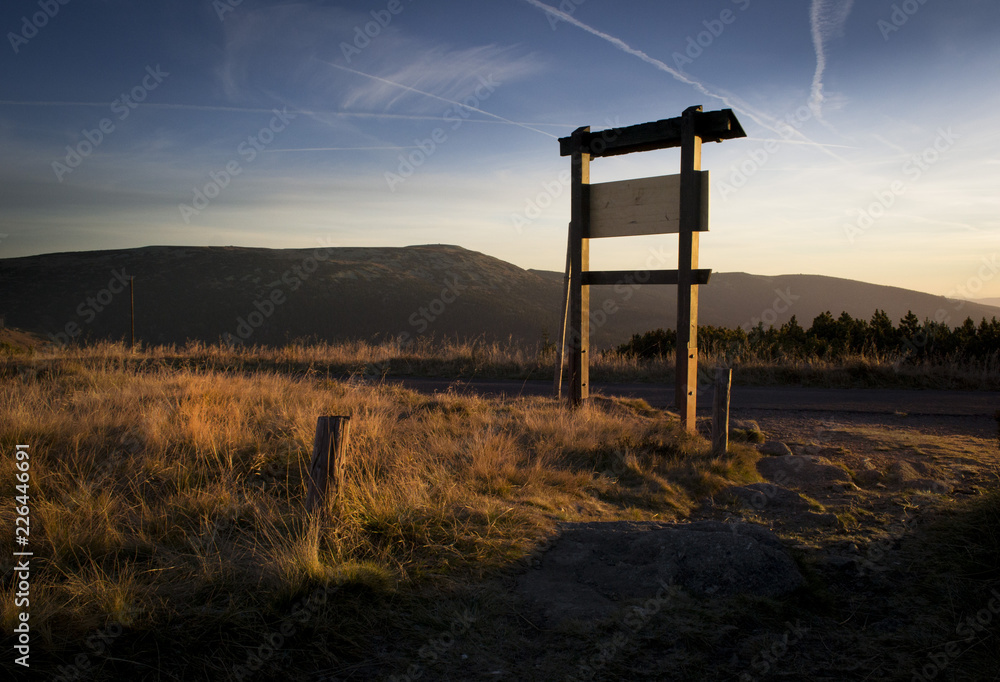 Beautiful outdoor tourist sign in the mountain national park at sunset at sunrise