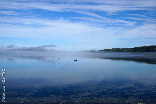 a northern bay in foggy summer morning