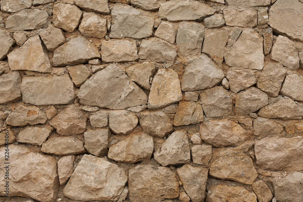 background stone wall of yellow color