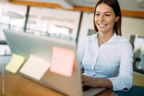 Free Download Portrait of businesswoman working on computer in office - GFXLoad