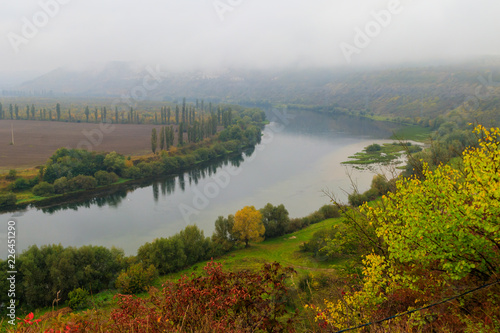 View of the Dniester river covered with a thick morning mist in autumn time