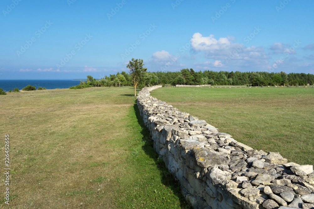 Stone fence on coastline.