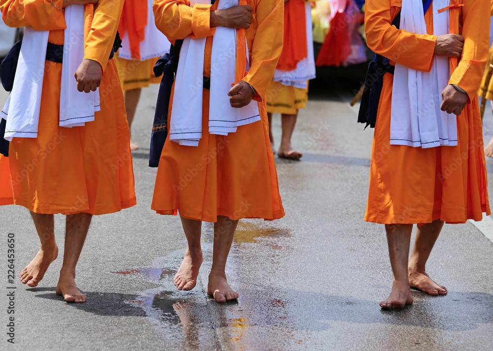 men of Sikh Religion with long orange clothes