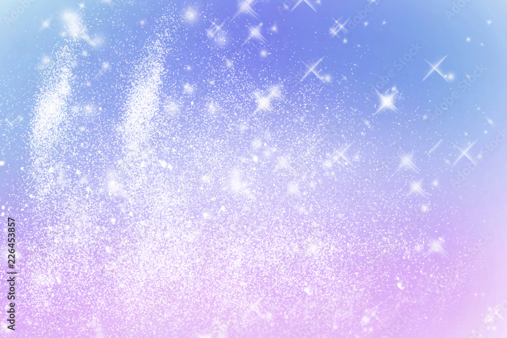 Winter shiny snowflakes blurred background in light blue pink colors. Blurry Christmas holiday background with snow flakes, frost pattern, soft flares of light. Copy space