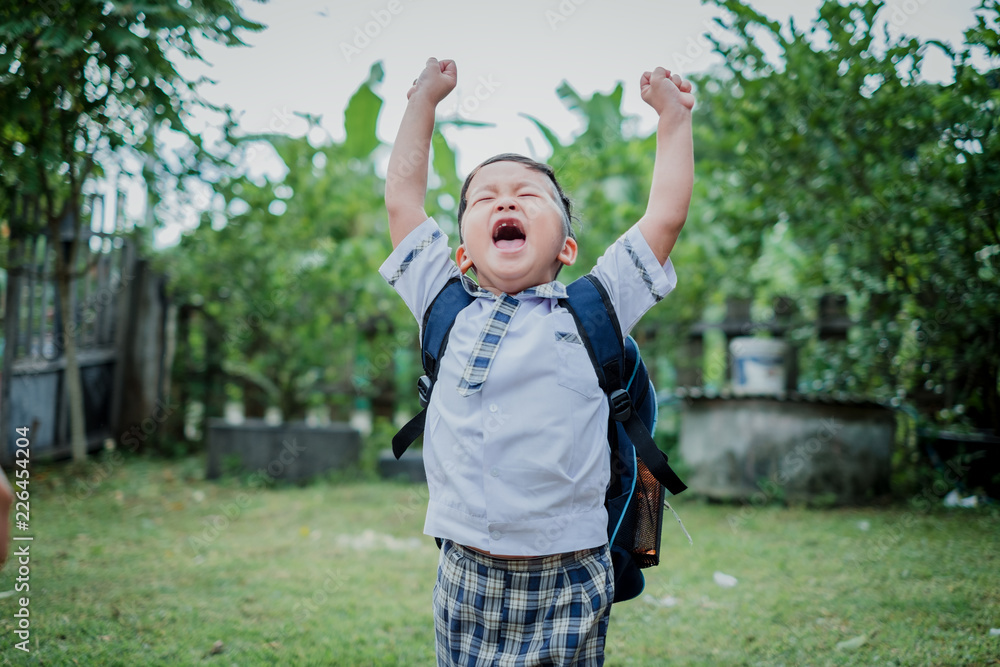 Happy children go back to school.Asian smiling boy with two fingers up going to school for the first time. Happy children go back to school.Asian smiling boy with two fingers up going to school for the first time.