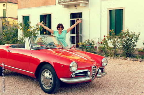 Montagnana, Italy August 27, 2018: Girl driving Retro car convertible 1961 ode release.