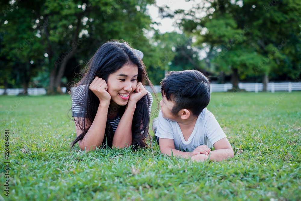 Happy mother and daughter laughing together outdoors Happy mother and daughter laughing together outdoors