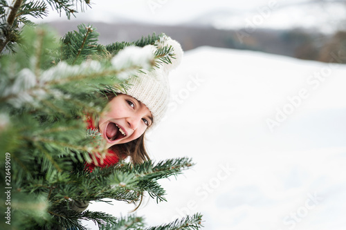 A small girl having fun in snow.