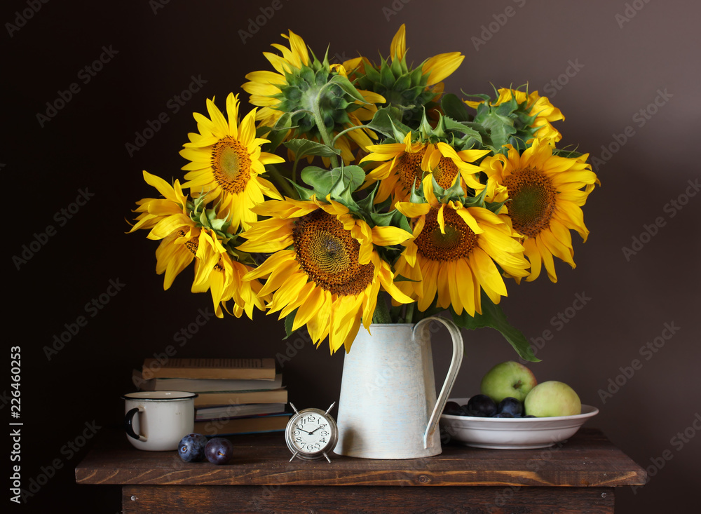 Fototapeta premium Still life with a bouquet of sunflowers and fruits.