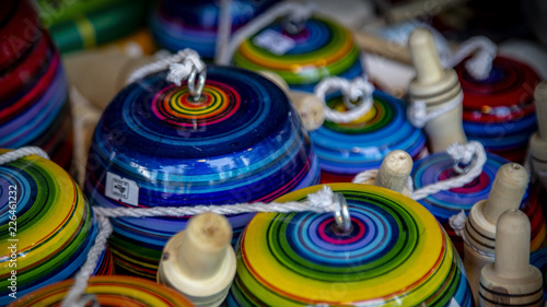 Isolated, close up view of colorful wooden toy spinning tops