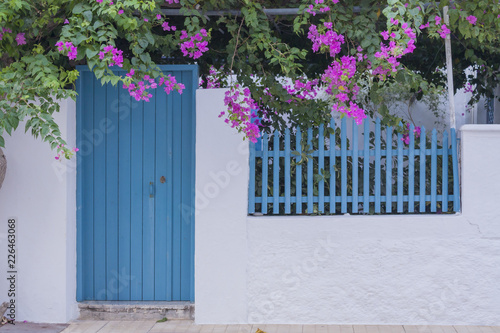 Traditional greek house with a blue door and window