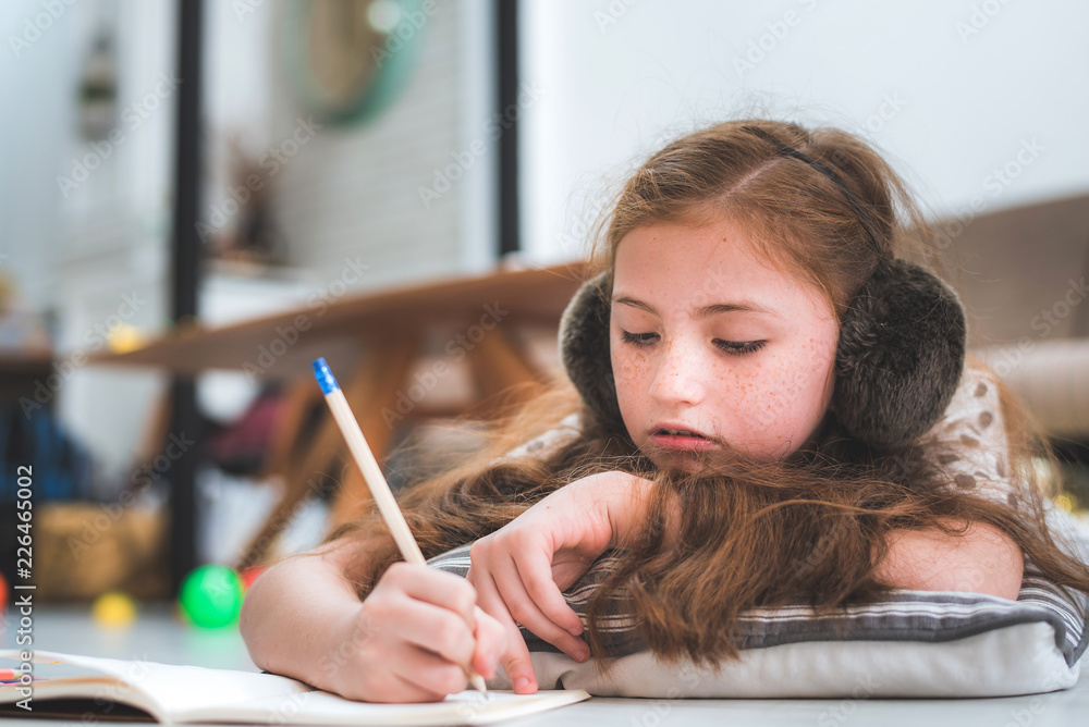 little cute girl studying and writing on notebook at home, education concept little cute girl studying and writing on notebook at home, education concept