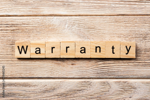 warranty word written on wood block. warranty text on table, concept photo