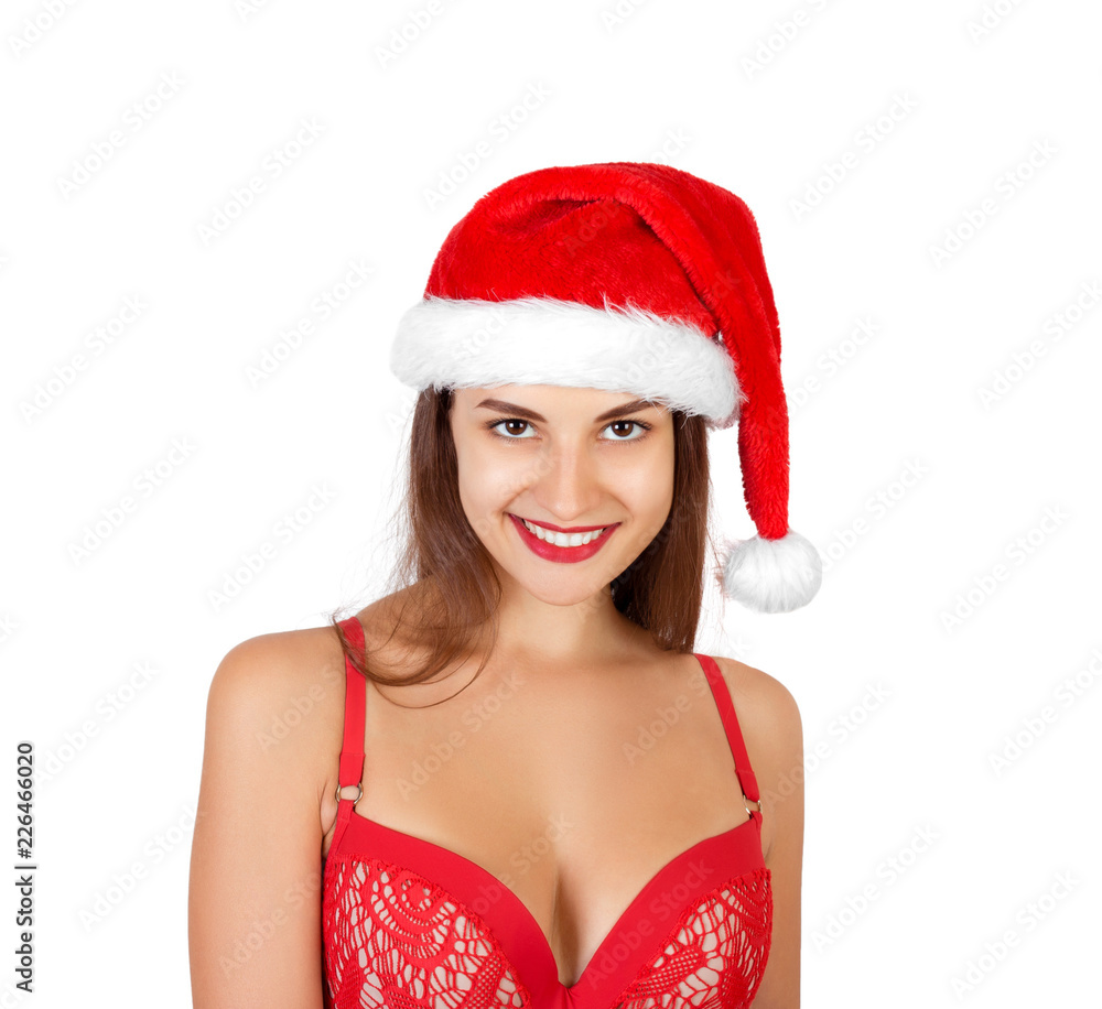 Portrait of happy excited pretty smiling girl in christmas hat and swimsuit. emotional woman in red santa claus hat isolated on white background. Happy Christmas and New Year holidays concept Portrait of happy excited pretty smiling girl in christmas hat and swimsuit. emotional woman in red santa claus hat isolated on white background. Happy Christmas and New Year holidays concept