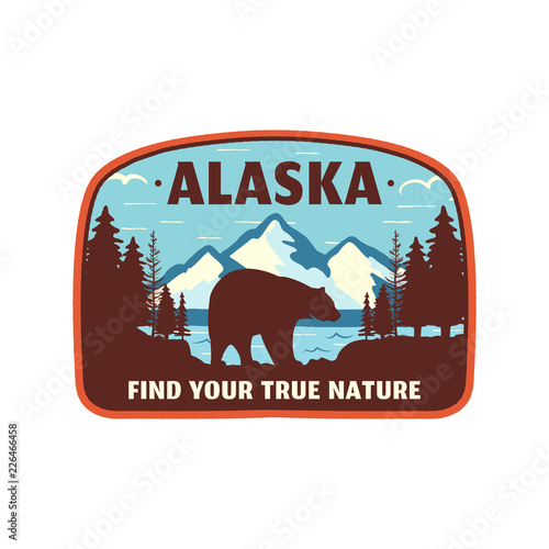 Alaska badge design. Mountain adventure patch. American travel logo. Cute retro style. Find your true nature custom quote. Bear walking through the forest. Stock vector emblem