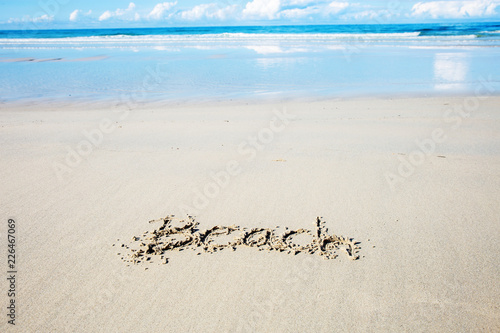Wording of beach on sand.