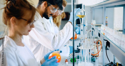 Young students of chemistry working in laboratory