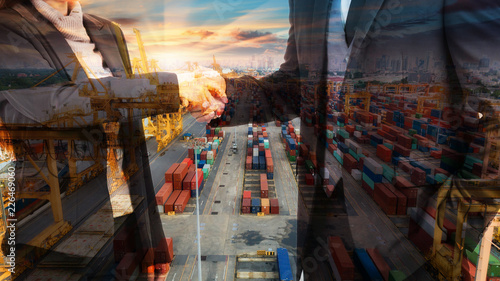 Double exposure business man and woman shake hand with Container warehouse background for delivery shipment transport, import export to global logistics concept.