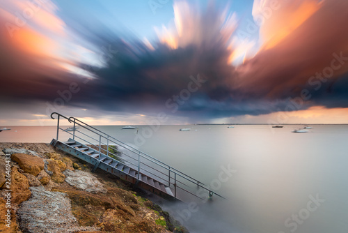 Escalier entrant dans l'eau au coucher du soleil