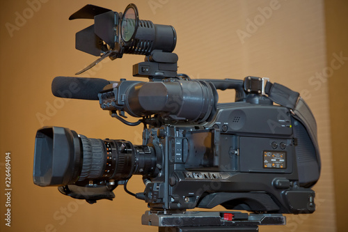 Professional video camera set on a tripod with excellent clipping path . Professional production video camera. video camera in business conference room recording participants