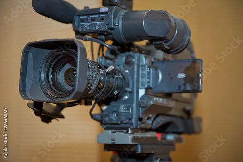 Professional video camera set on a tripod with excellent clipping path . Professional production video camera. video camera in business conference room recording participants