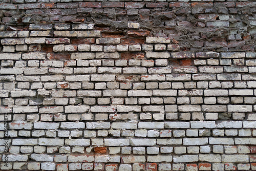 Ruined brick wall. Surface weathered by time