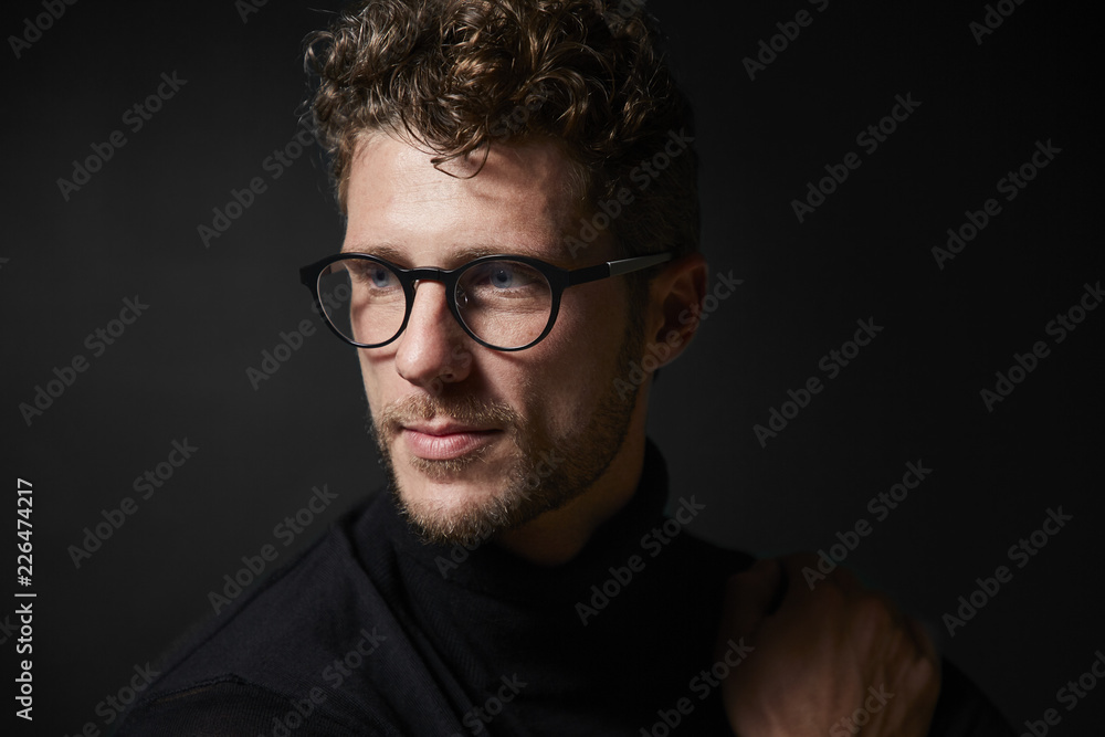 Smart guy in glasses, looking away