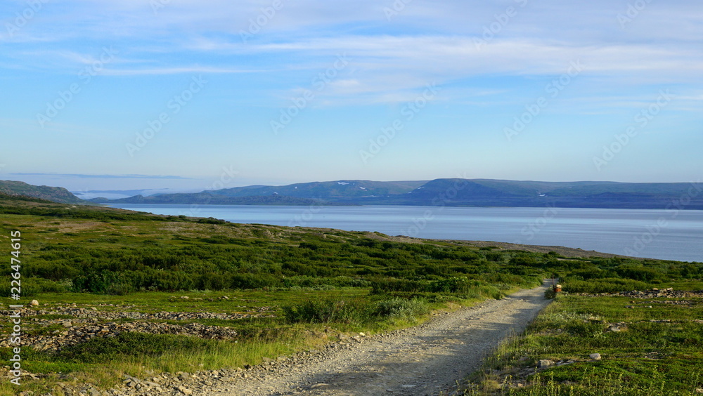 landscape with road to the coastline and clouds