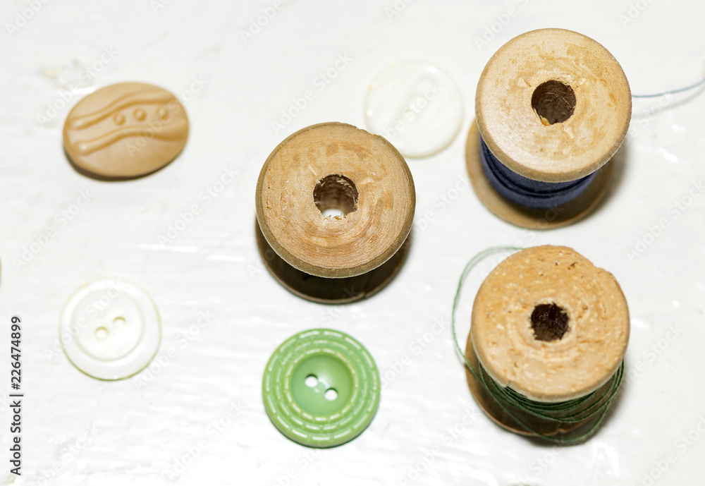 wooden spools of thread and ceramic and plastic buttons wooden spools of thread and ceramic and plastic buttons