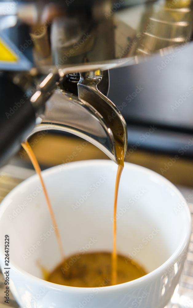 Barista making a cup of coffee soft focus image .