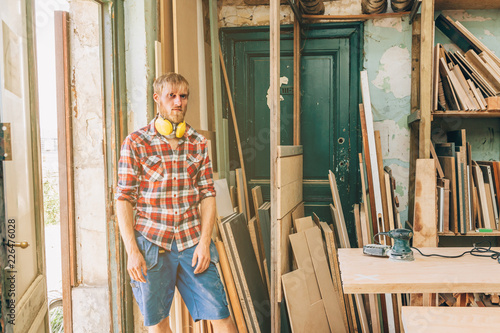 portrait of a self confident carpenter in his workshop