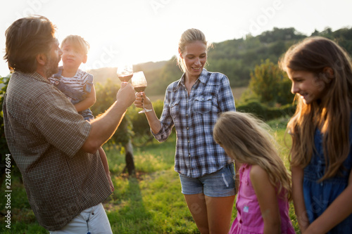 Wine grower family in vineyard before harvesting