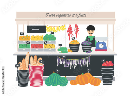 Greengrocer seller standing at counter, stall or kiosk with scales, fruits, vegetables and bread